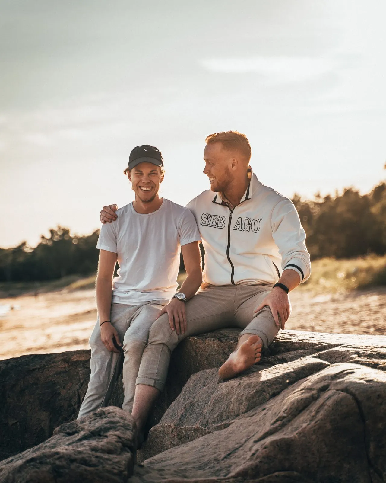 Viktor Åkerlund and Philip Larsson laughing together on the rocks by the sea in Halmstad
